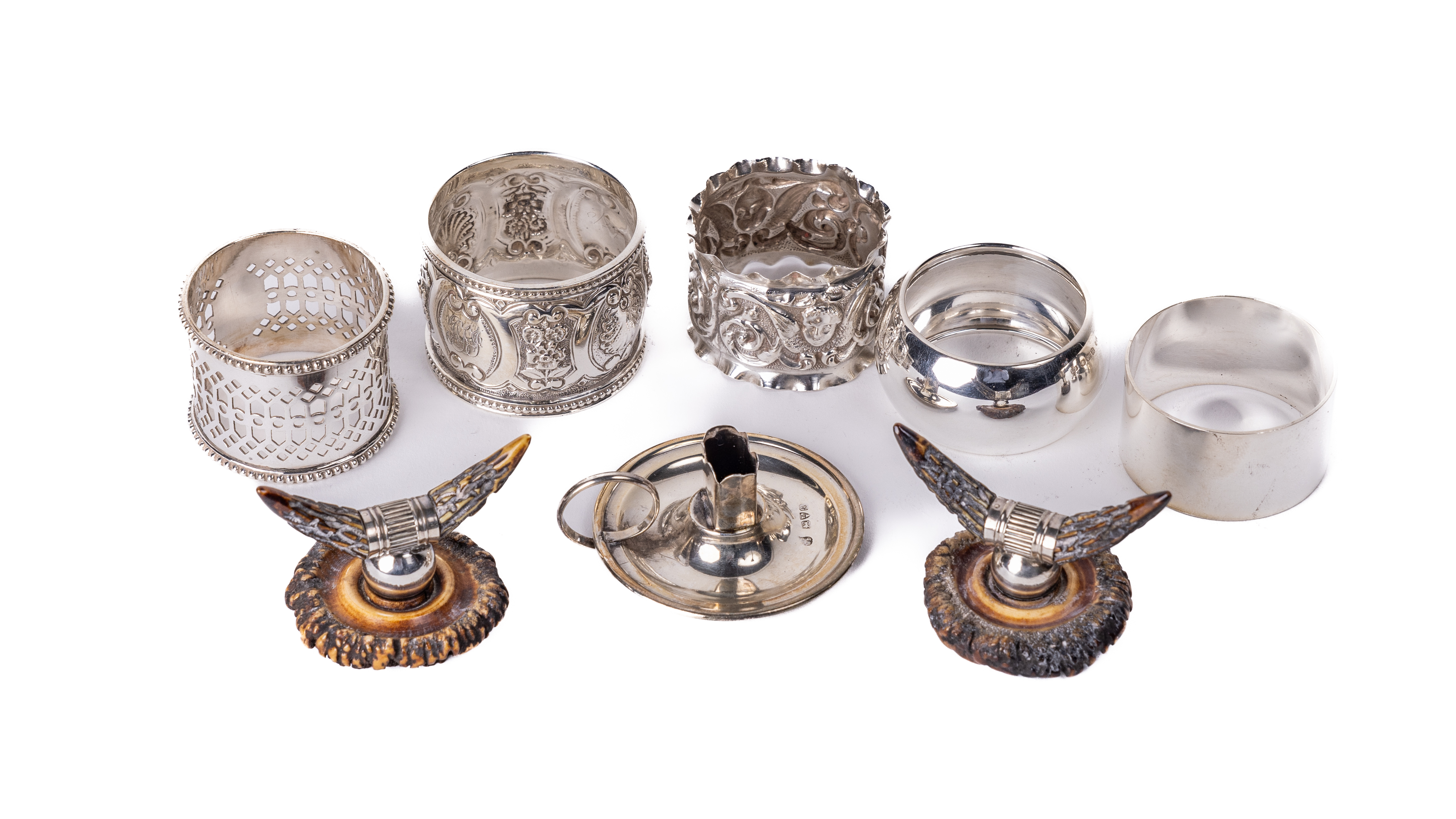 A group of five silver varied designed, pierced and decorated Napkin Rings, a small silver