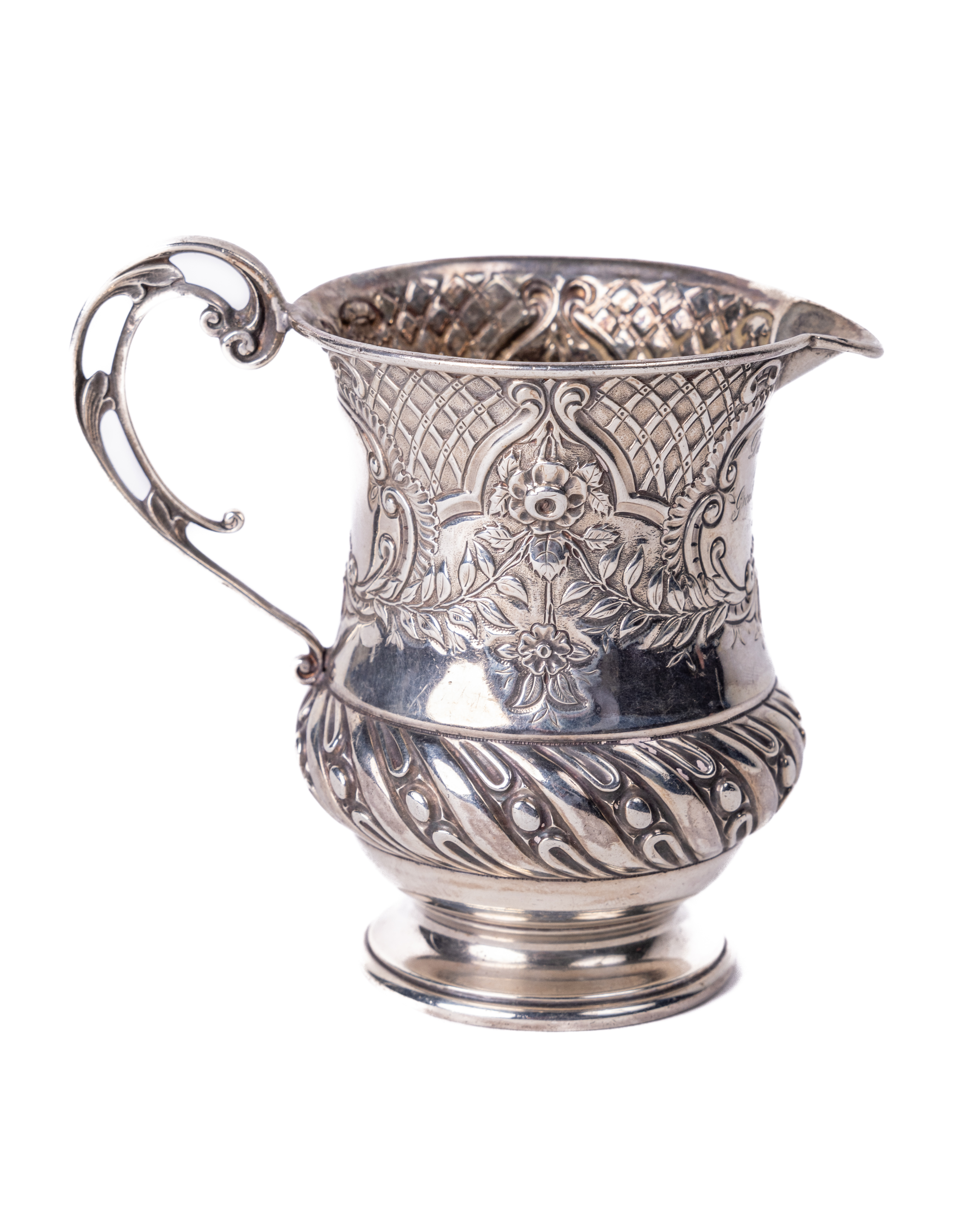 An attractive English silver Christening Jug, (added beak) of rococo repoussé design, with floral