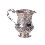 An attractive English silver Christening Jug, (added beak) of rococo repoussé design, with floral