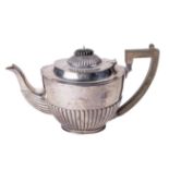 A large English Georgian style silver Teapot, with reeded hinged domed lid and similarly decorated