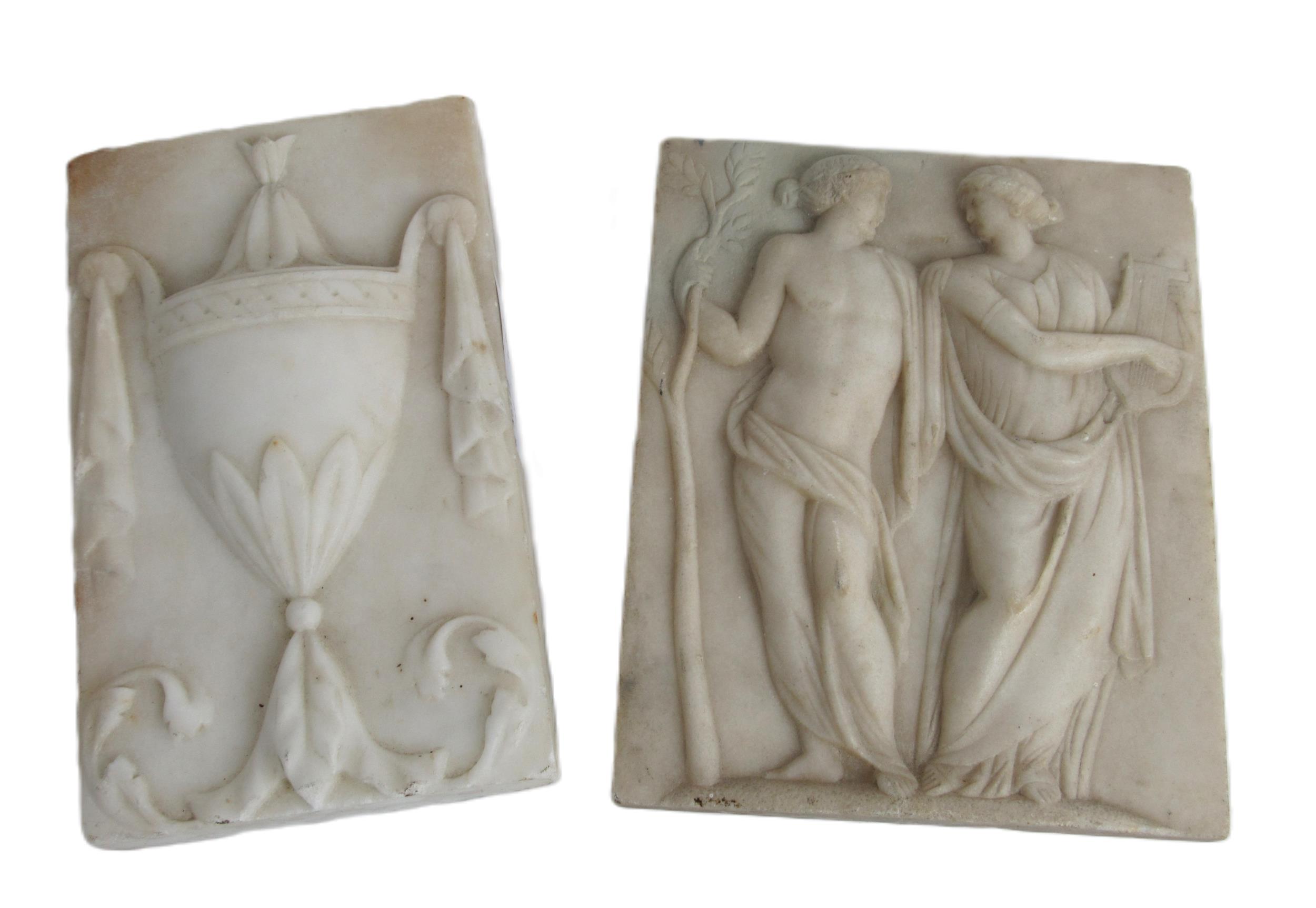 An early carved marble fireplace Panel, depicting classical male and female figures in conversation,
