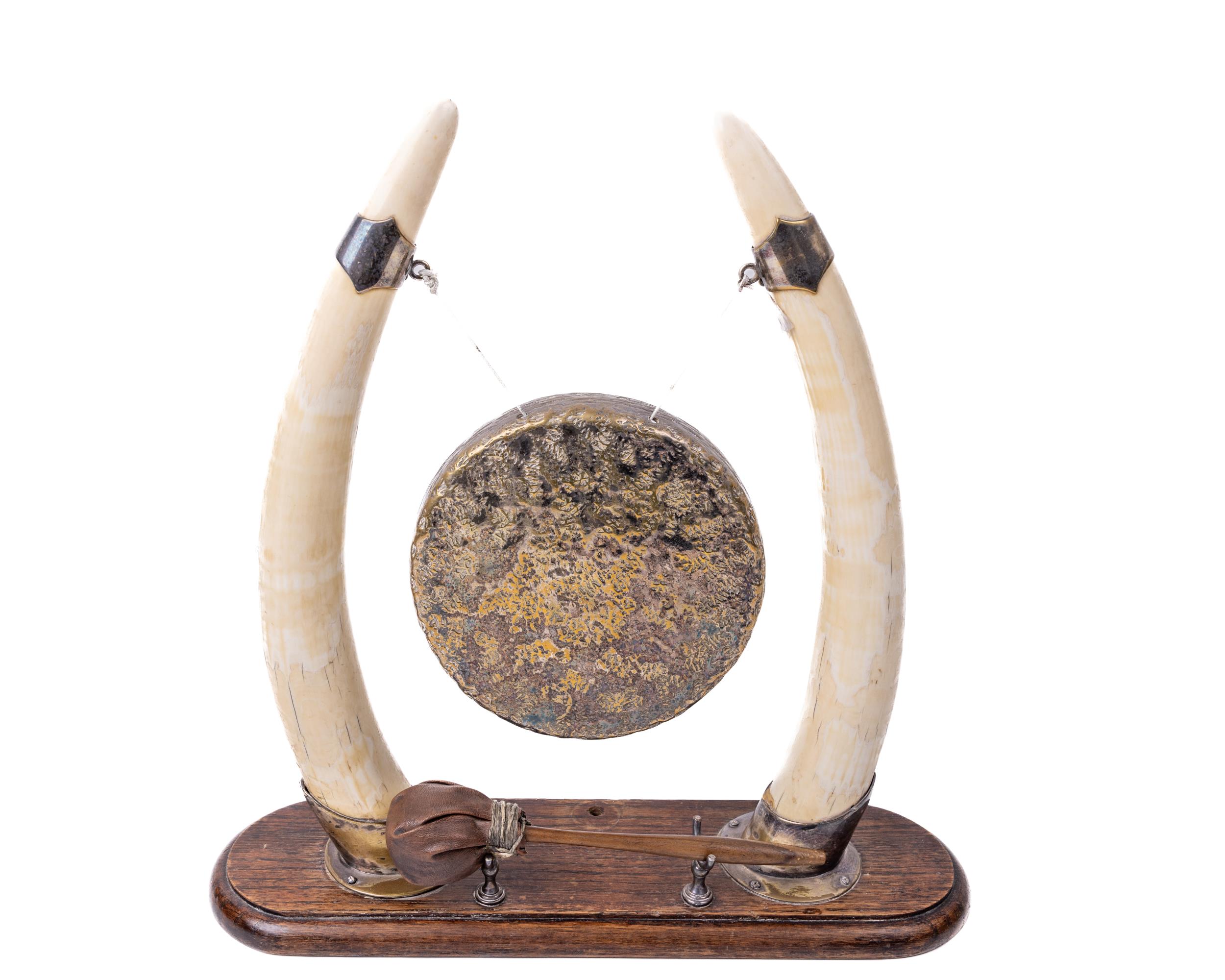 A late Victorian Dinner Gong, formed between two horns with plated mounts and brass suspended