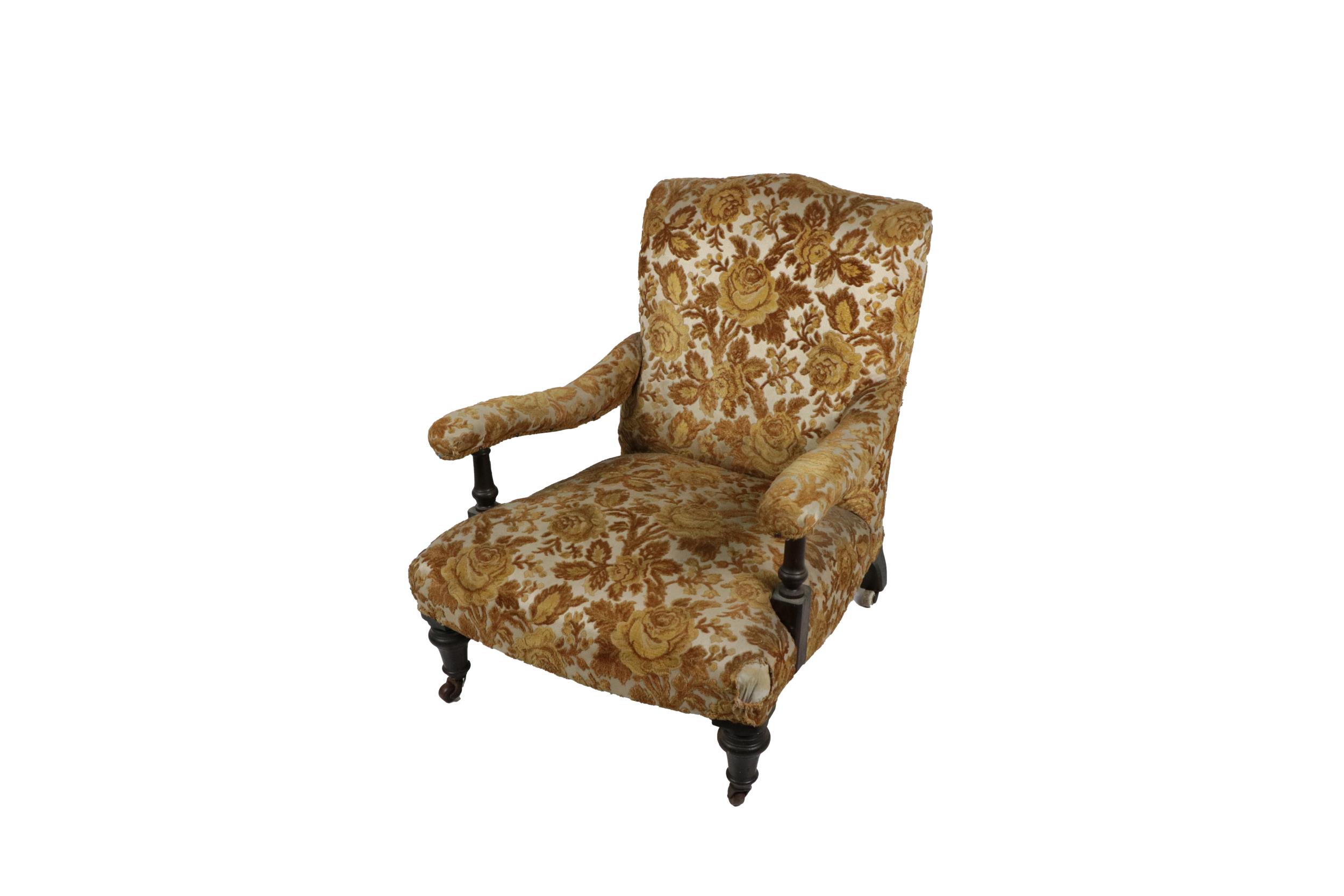 A Victorian mahogany framed Low Armchair, covered in floral brocade in the manner of Howard, on