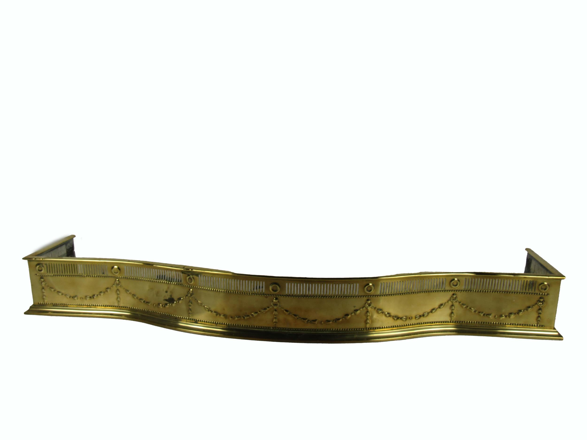 An Edwardian bow fronted brass Fender, decorated in the Adams taste, with pierced design, approx.