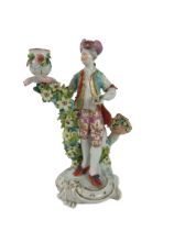 A very good 18th Century flower encrusted Derby Figural Candlestick, 25cms high. (1) Provenance: The