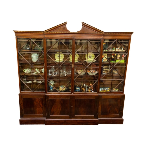 A fine George III inlaid mahogany breakfront Library Bookcase, the divided pediment above an