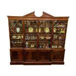 A fine George III inlaid mahogany breakfront Library Bookcase, the divided pediment above an