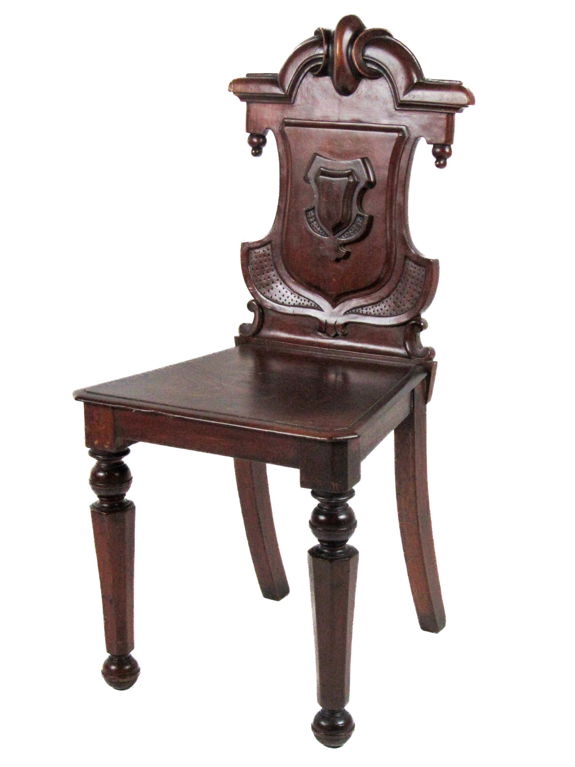 A Victorian mahogany shield back Hall Chair, with carved back over solid seat on front octagonal