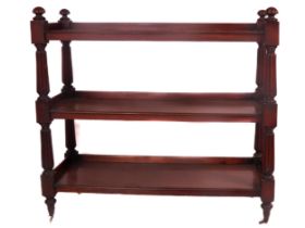 An Irish William IV mahogany three tier Dumbwaiter, with reeded pillar supports and curved finials