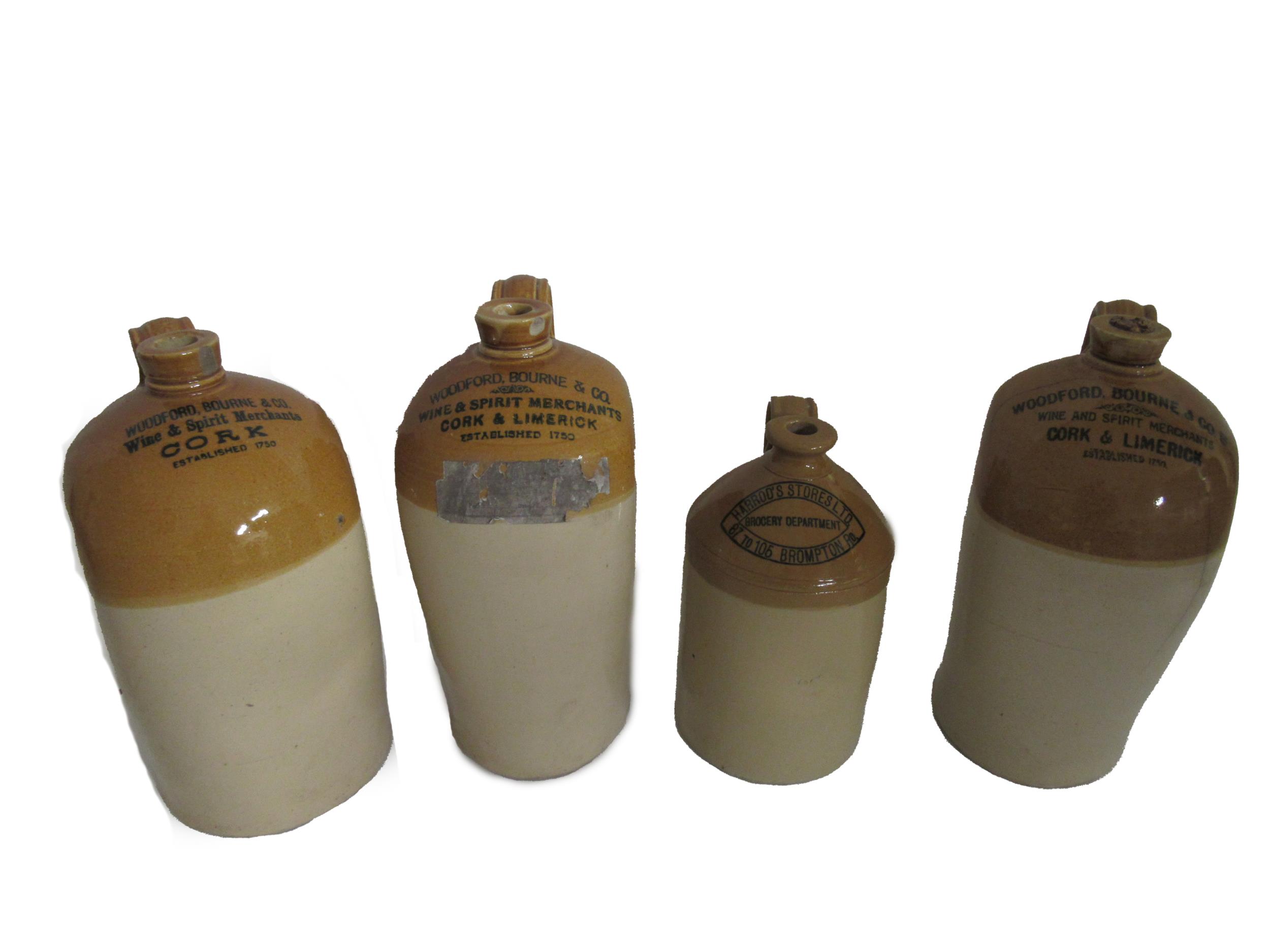 A collection of 4 Earthenware Irish and other Spirit Jars, for Woodford Bourne and Co. Limerick