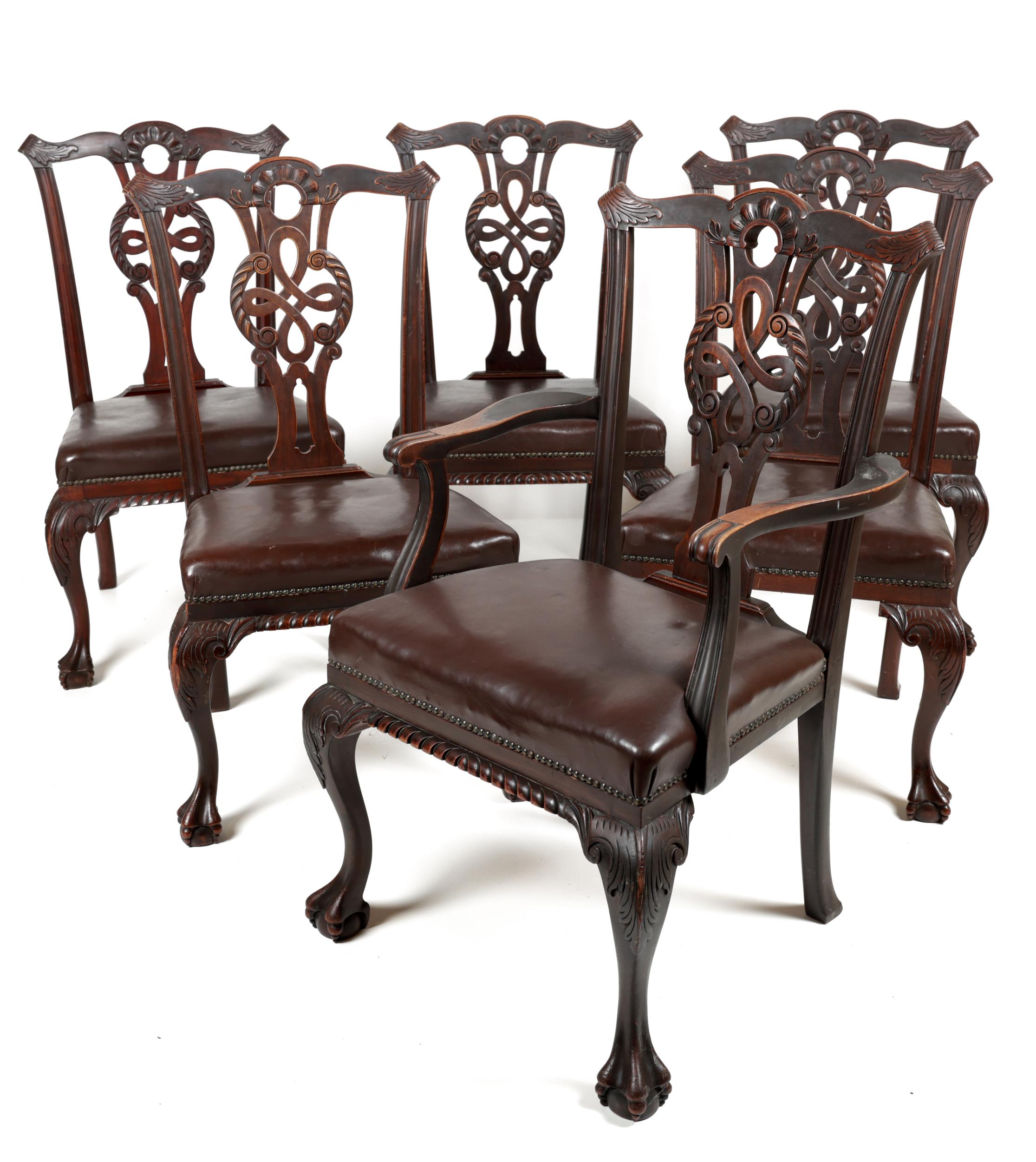 A set of 12 (10 + 2) Irish Chippendale style Dining Chairs, in the manner of Butler, Dublin, each