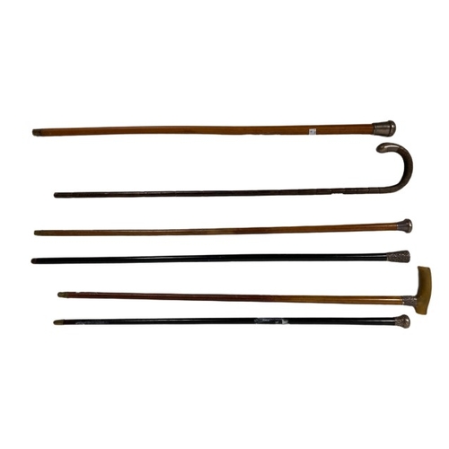Two silver mounted ebony Walking Sticks, three silver mounted Malacca Walking Canes, one with horn