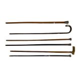 Two silver mounted ebony Walking Sticks, three silver mounted Malacca Walking Canes, one with horn