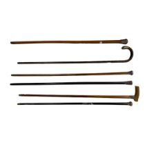 Two silver mounted ebony Walking Sticks, three silver mounted Malacca Walking Canes, one with horn