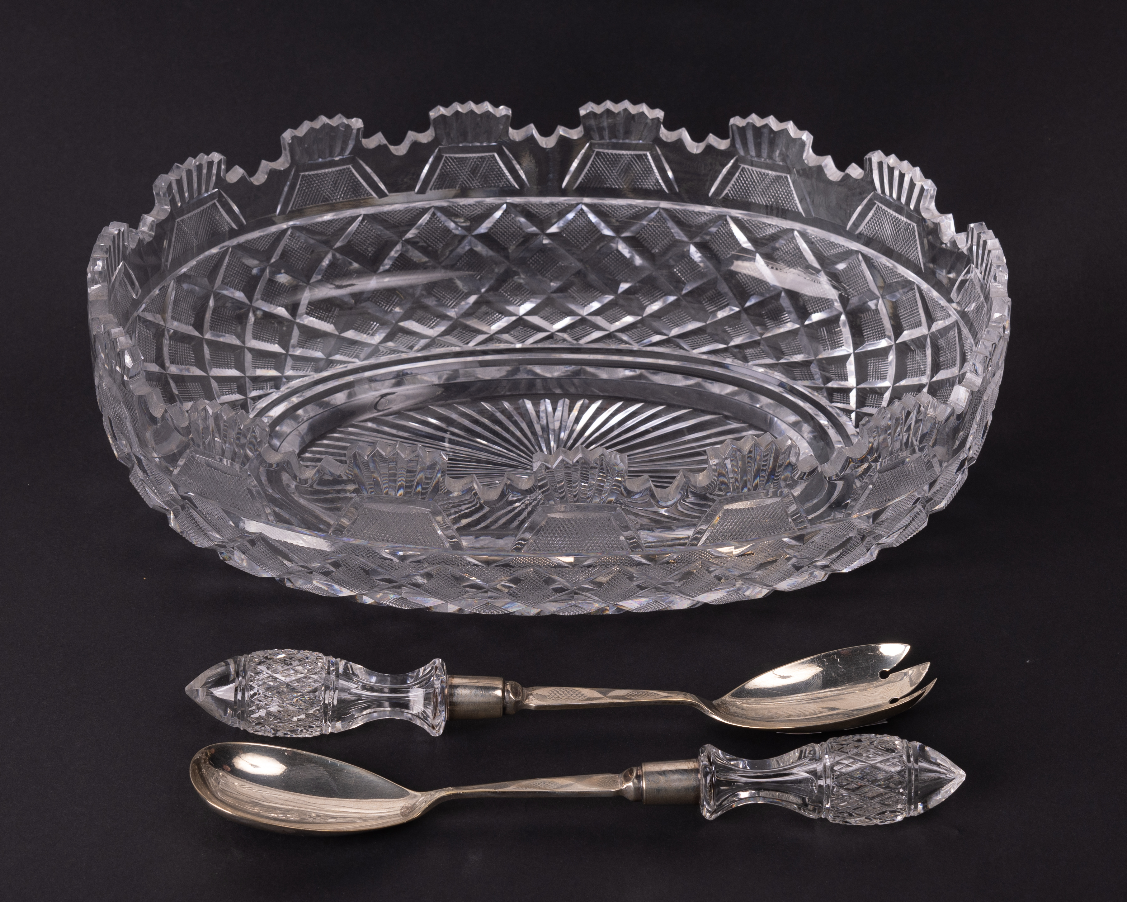 An attractive cutglass Salad Bowl, of oval shape with matching cutglass handles and silver mounted