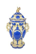 A large attractive English porcelain two handled blue ground cream decorated Urn and Cover, the