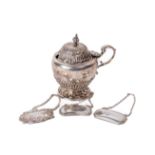 An English silver Mustard, with domed hinge lid and finial, 'S' scroll handle on circular base, mark