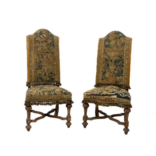 A pair of Louis XIV style walnut Side Chairs, on reeded shaped legs united by X stretchers,