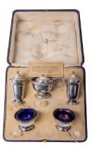 A cased English silver Condiment Set, comprising salt and pepper shakers, mustard pot, and pair of
