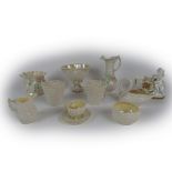 A varied collection of Belleek Ware, comprising basket ware Bowl, floral encrusted Jugs, Cups