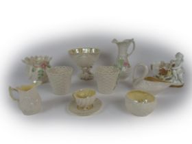 A varied collection of Belleek Ware, comprising basket ware Bowl, floral encrusted Jugs, Cups