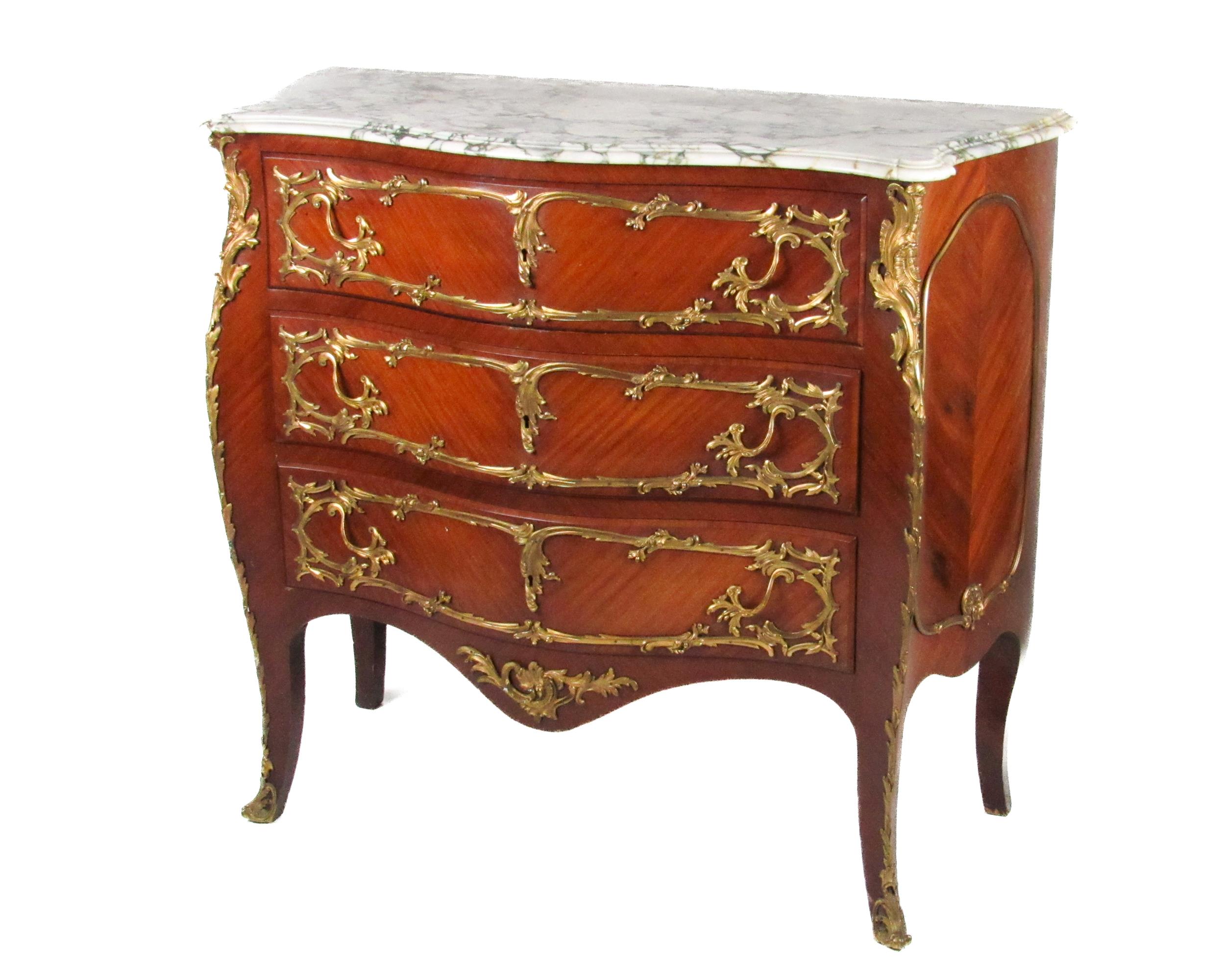 A French style kingswood bombe shaped Commode, the moulded marble top over three long drawers with