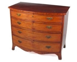 A Georgian mahogany bow fronted Chest of Drawers, the plain top over four long drawers with ornate