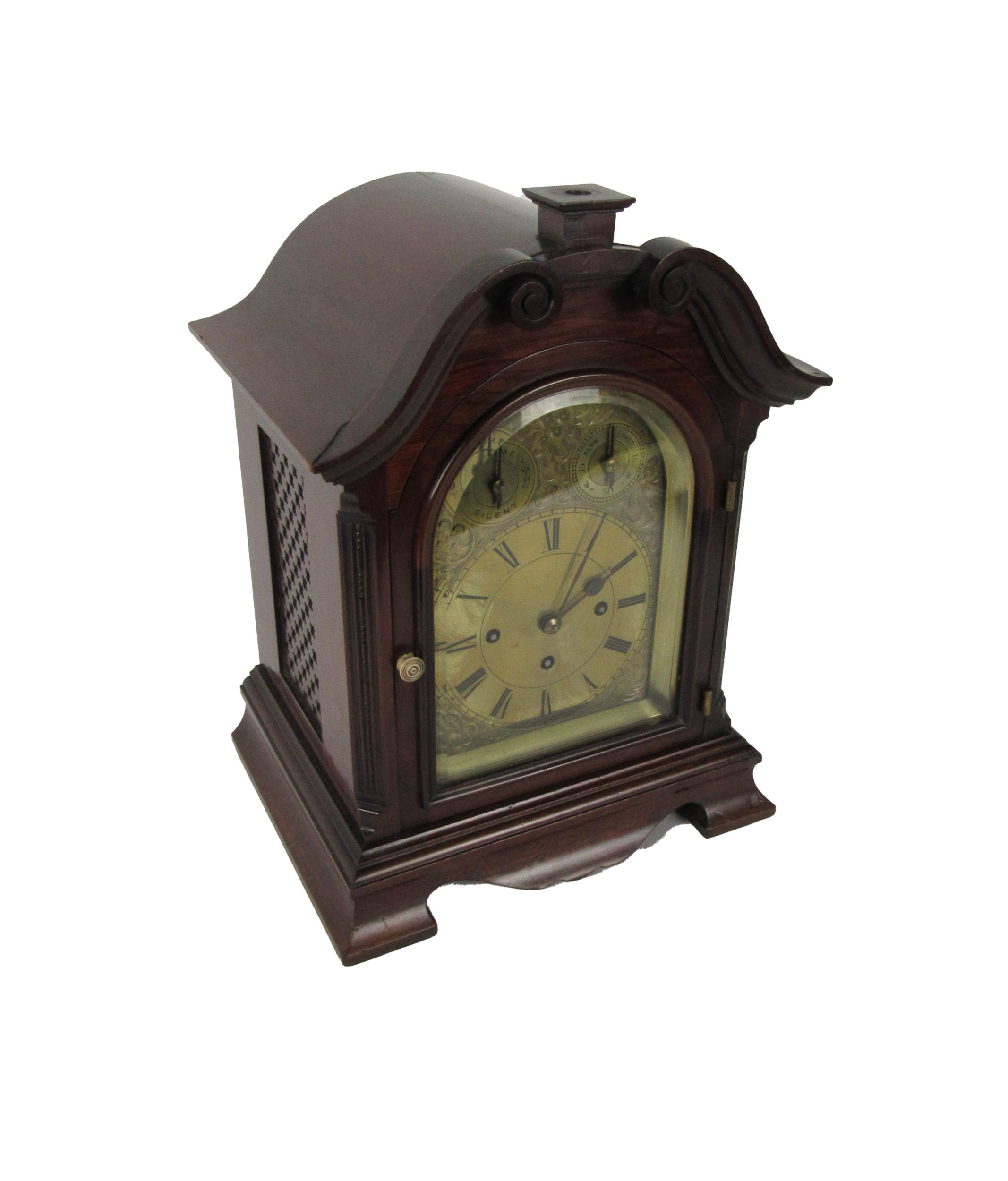An attractive mahogany cased Mantle Clock, with swan neck pediment over an arched glazed door