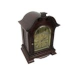 An attractive mahogany cased Mantle Clock, with swan neck pediment over an arched glazed door