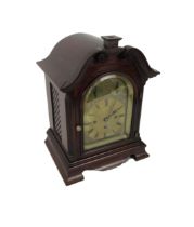 An attractive mahogany cased Mantle Clock, with swan neck pediment over an arched glazed door