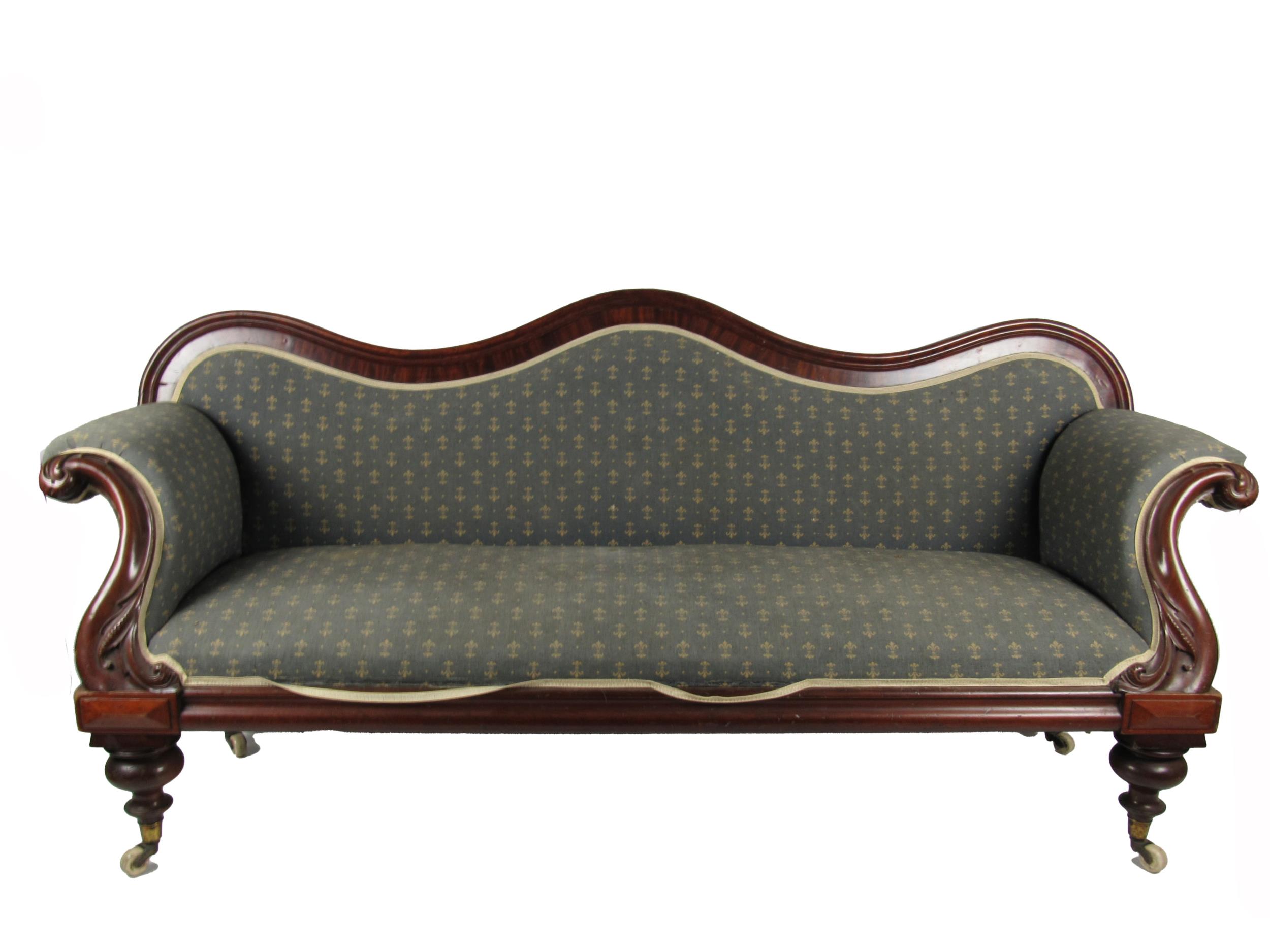 A Victorian mahogany framed Settee, in the manner of Strahan, the shaped back issuing padded seat