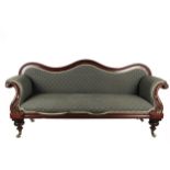 A Victorian mahogany framed Settee, in the manner of Strahan, the shaped back issuing padded seat