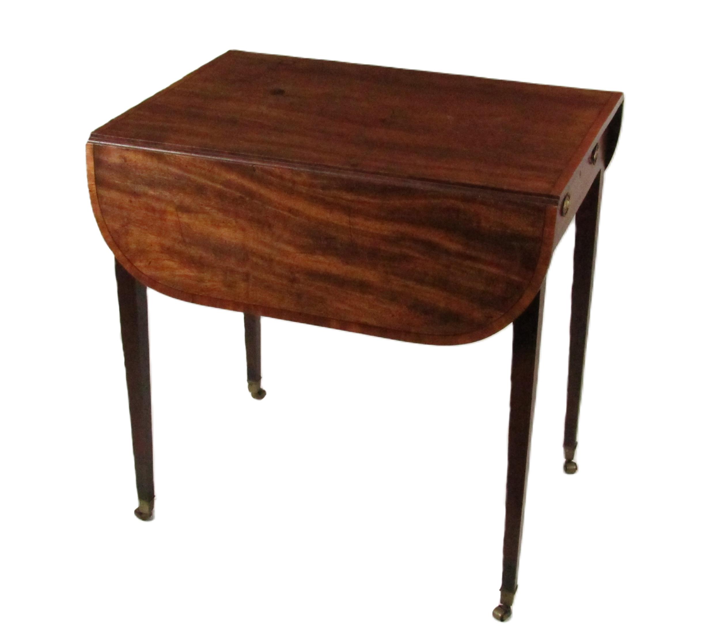 A Regency mahogany Pembroke Table, the top with ebony string inlay and crossbanded border, with demi