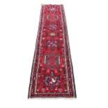 An antique Middle Eastern (Iranian) woolen Carpet Runner, the central panel with geometric lozenges,