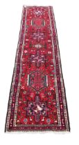 An antique Middle Eastern (Iranian) woolen Carpet Runner, the central panel with geometric lozenges,
