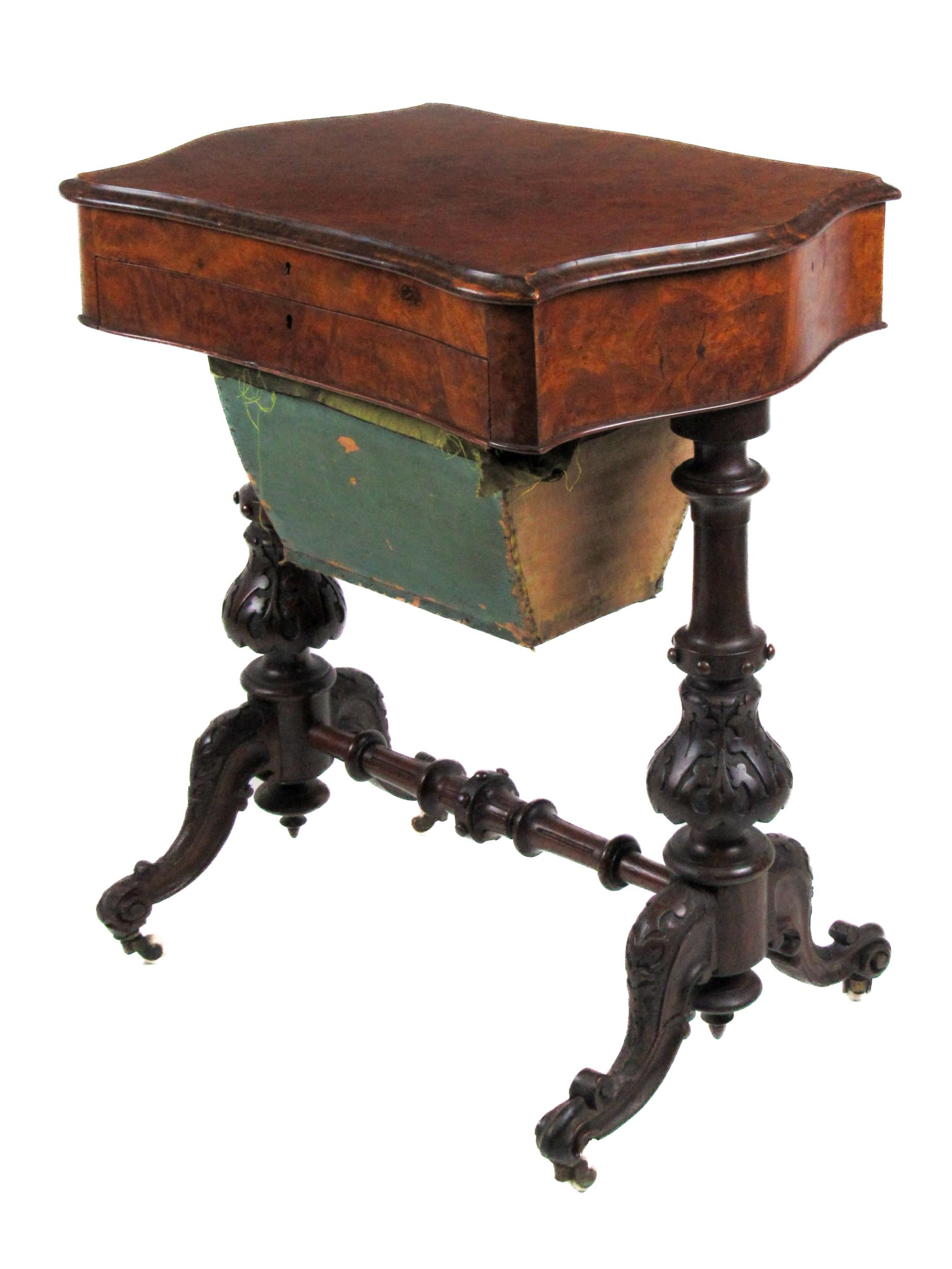 A Victorian serpentine shaped Ladies walnut Work / Writing Table, the hinged top opening to reveal a