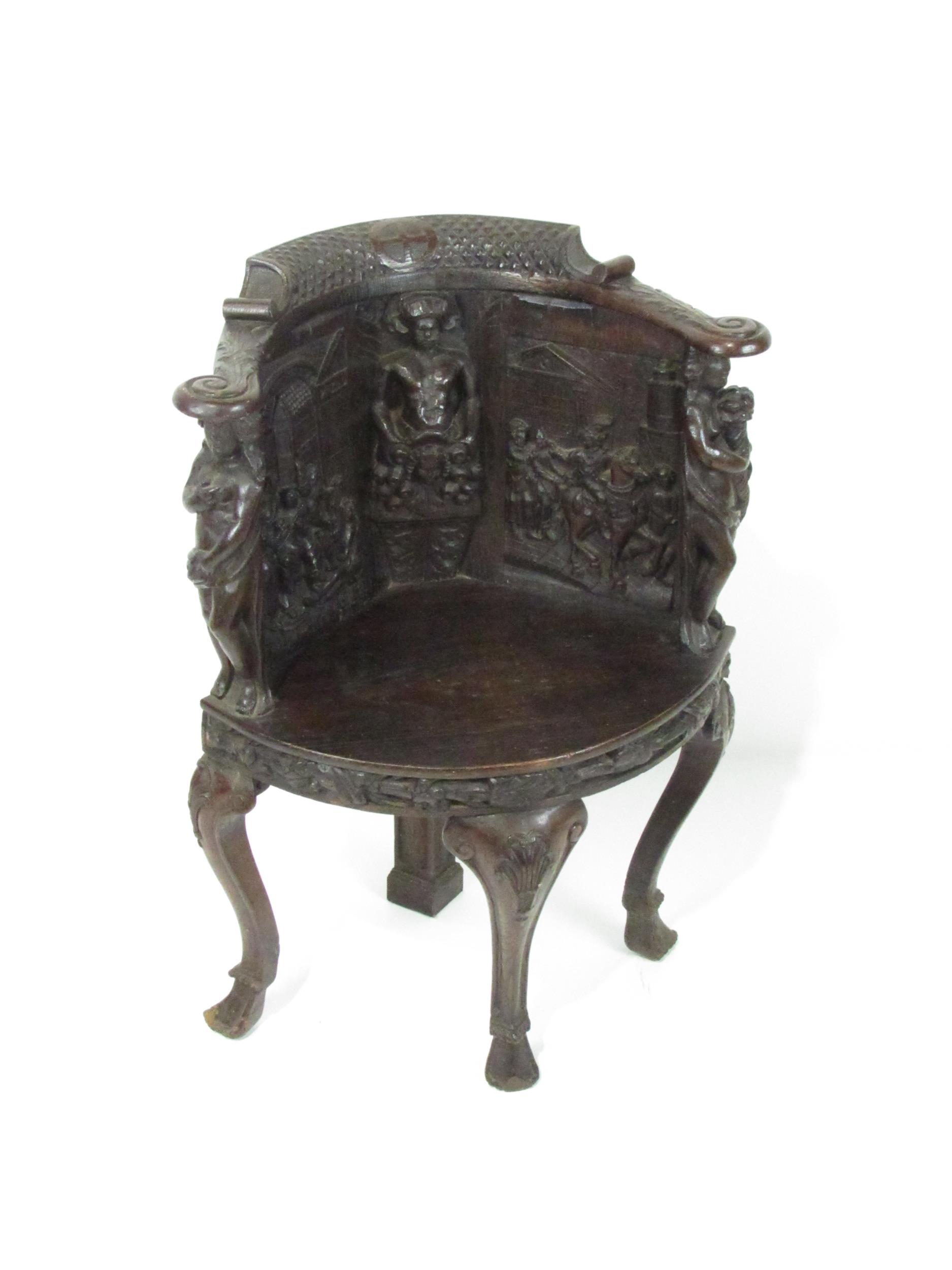 A 19th Century Cromwellian style carved oak Corner Chair, the panelled back with central figure,