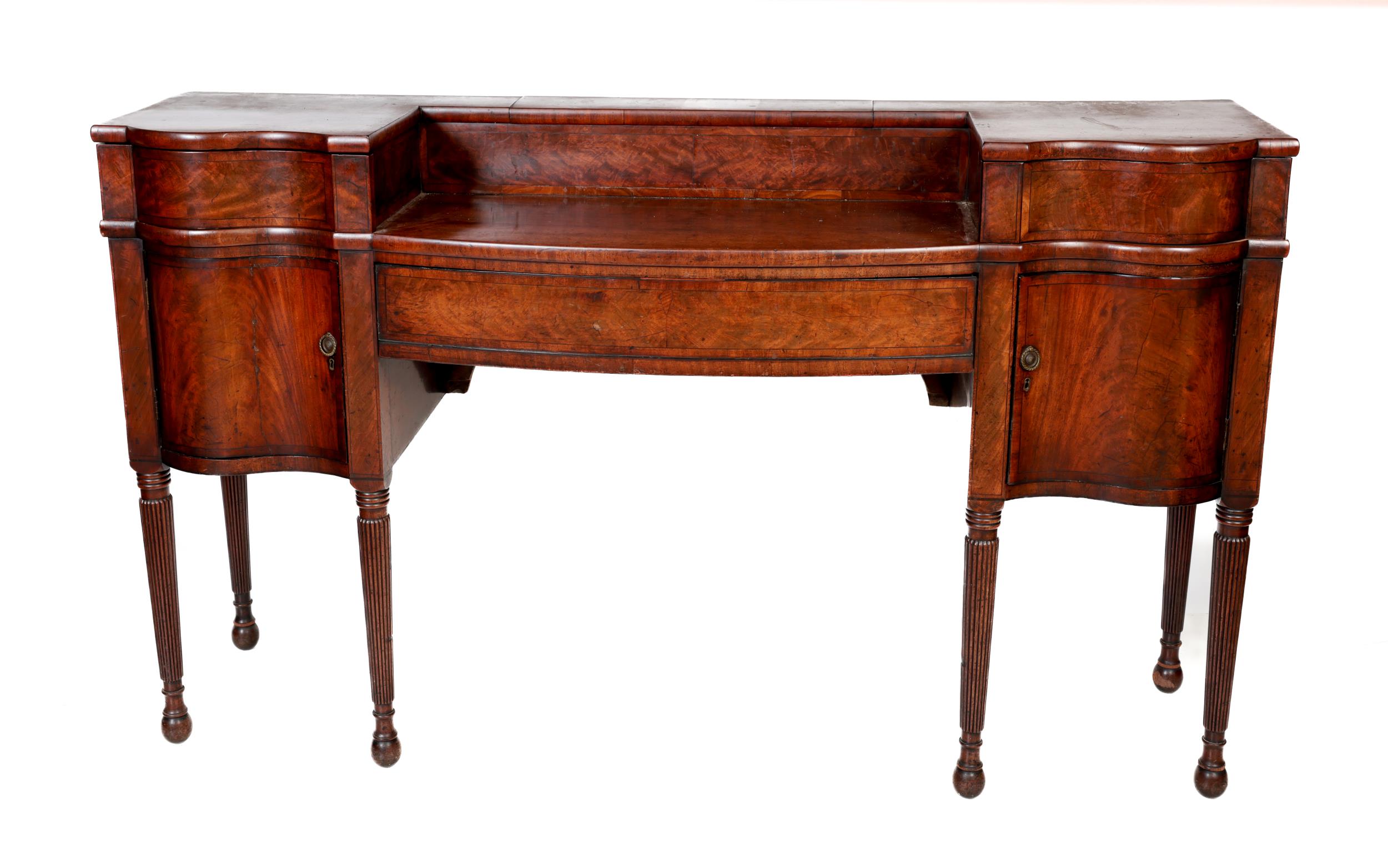 An Irish Georgian mahogany Serving Table, possibly Cork, the serpentine and bowed top with