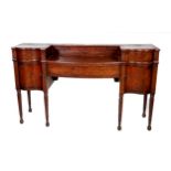 An Irish Georgian mahogany Serving Table, possibly Cork, the serpentine and bowed top with