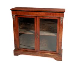 A Victorian walnut Credenza, the plain top over inlaid frieze above two glazed doors, with ornate