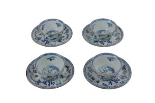 An early set of four Chinese 'Doucai,' blue and white Tea Cups and Saucers, decorated with birds and