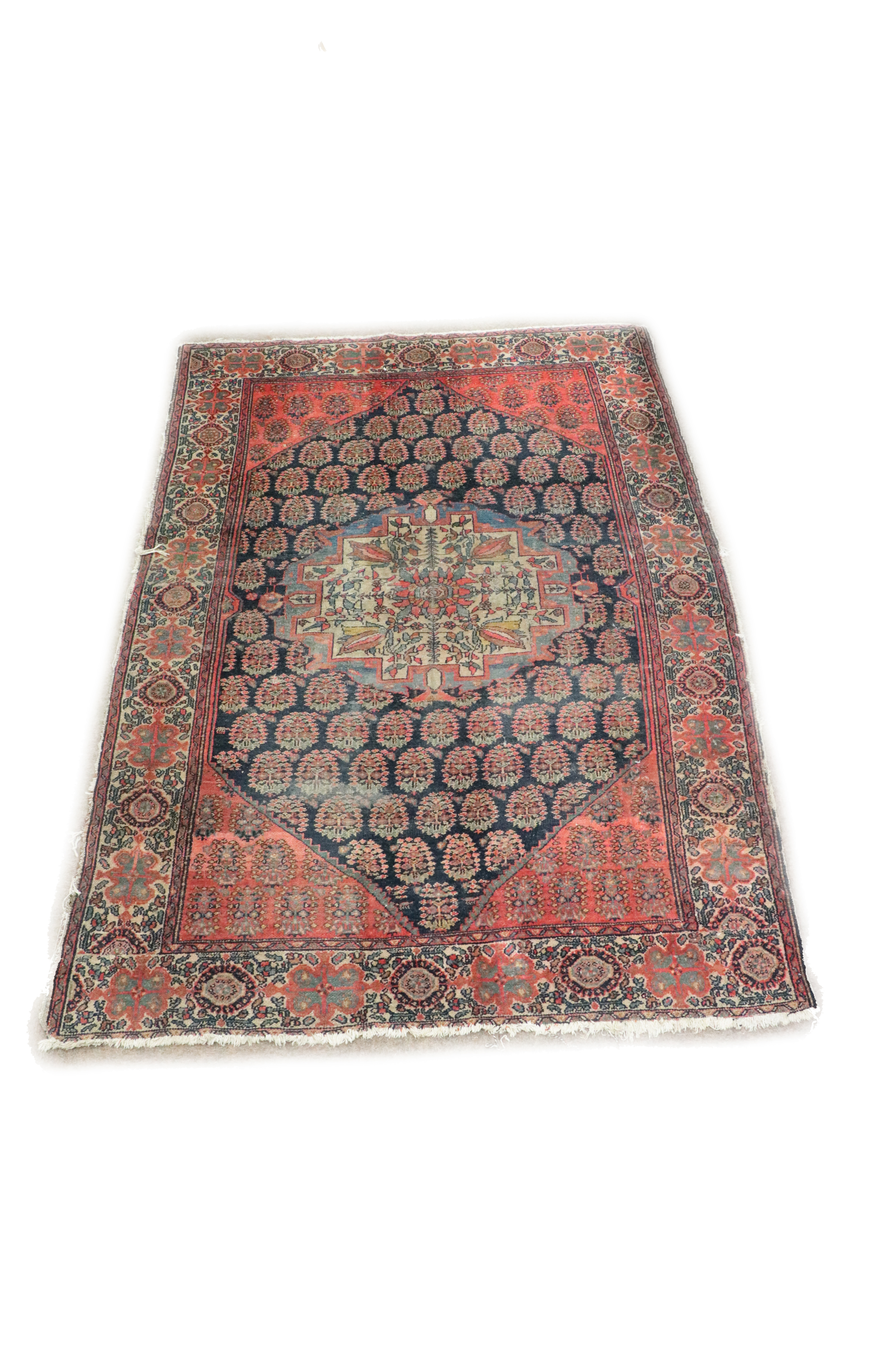 An antique Middle Eastern woolen Carpet, (possibly Persian), t