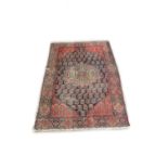 An antique Middle Eastern woolen Carpet, (possibly Persian), t