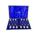A cased set of 12 Apostle type Teaspoons, with matching Sugar Tongs, by Walker & Hall, Sheffield, in