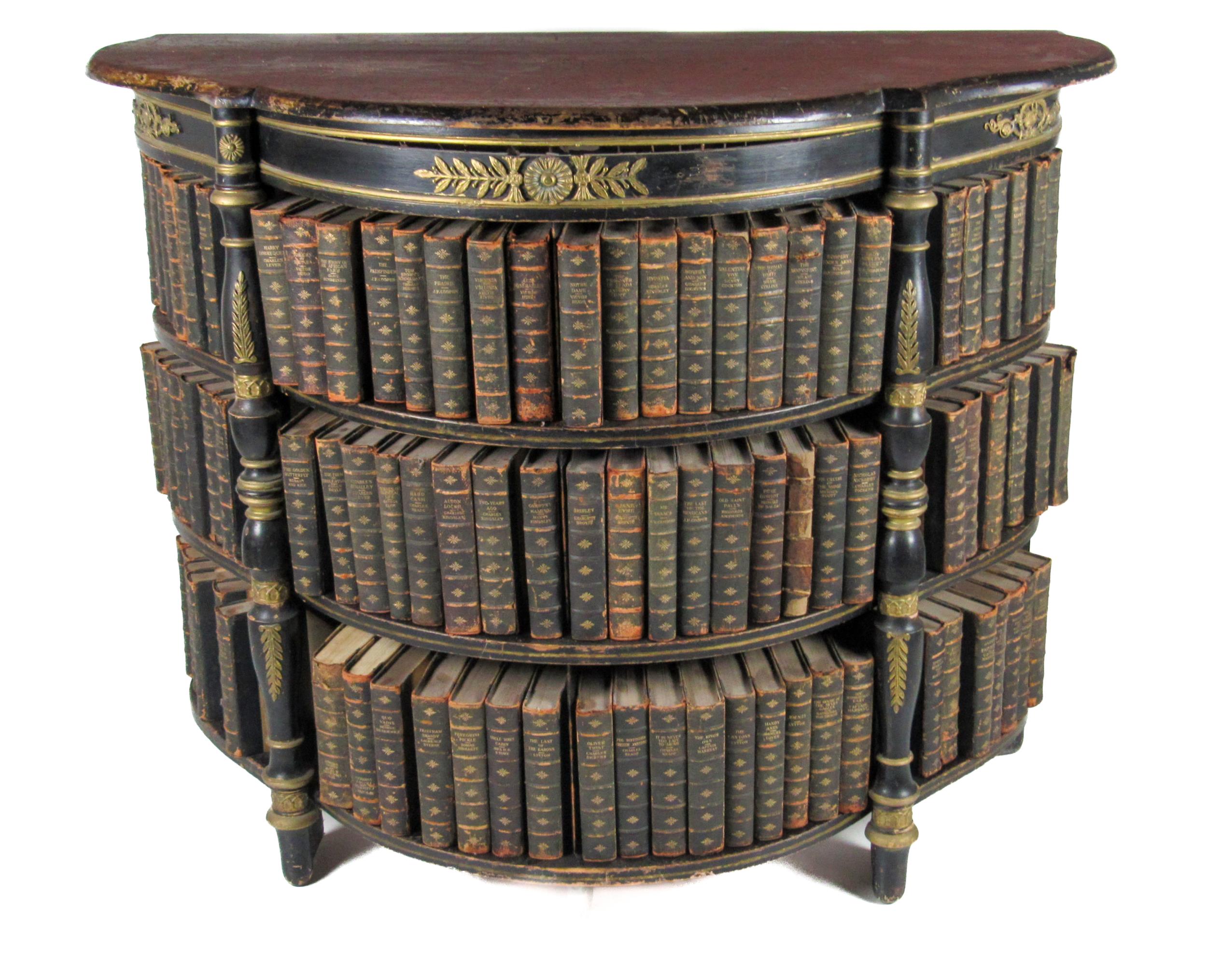A Regency style shaped ebonised and ormolu mounted Open Bookcase, with three sections and three