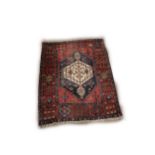 An antique Middle Eastern Rug, the rectangular central panel on a blue ground with large single