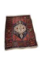 An antique Middle Eastern Rug, the rectangular central panel on a blue ground with large single