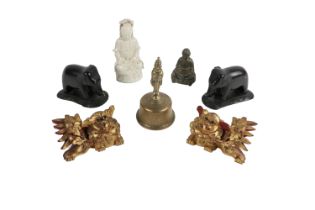 A blanc-de-chine Figure of a Buddha, a pair of carved ebony Elephants, a heavy engraved brass Bell