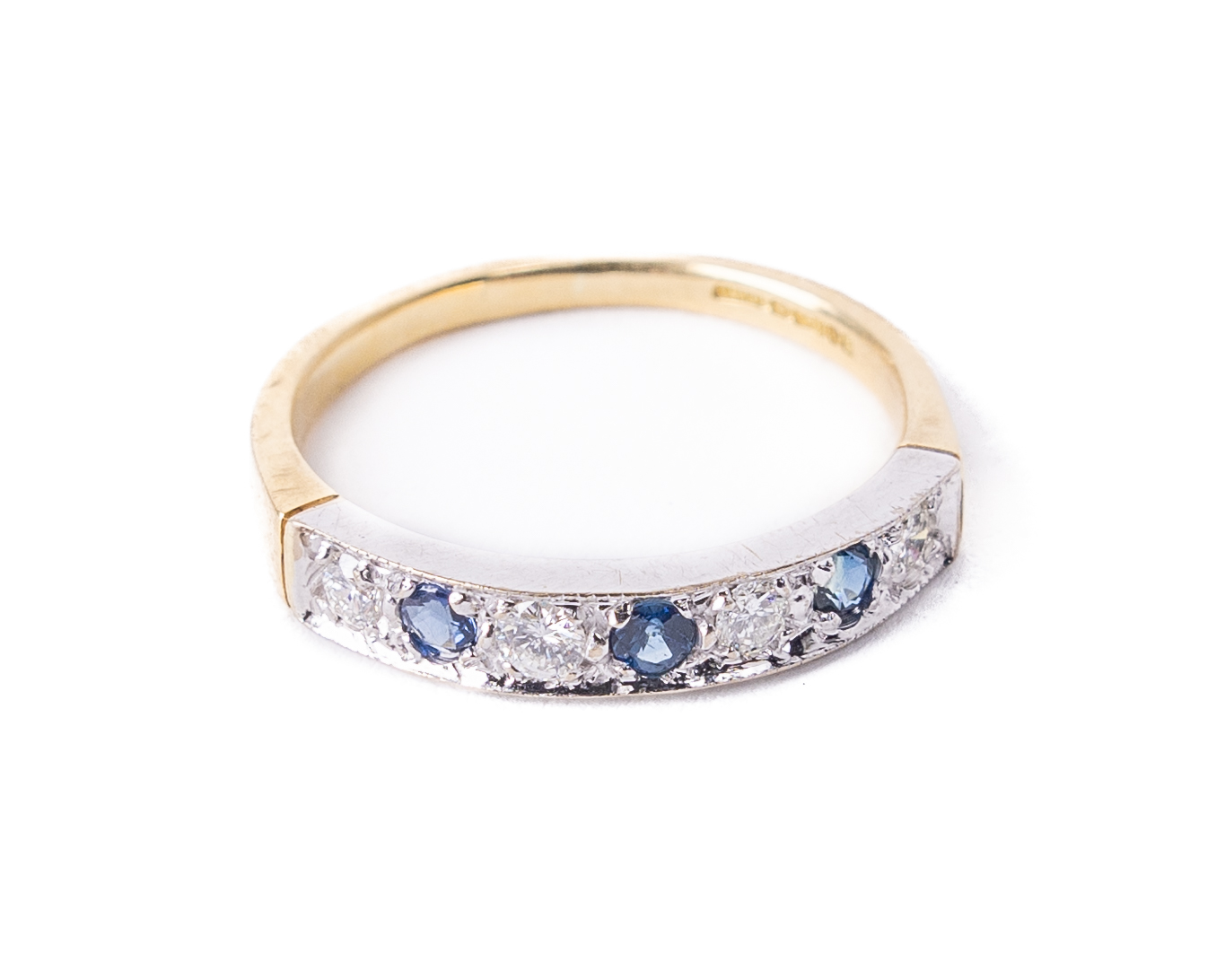 A fine quality sapphire and diamond Ladies Eternity Ring, set with four .06ct diamonds, and three .