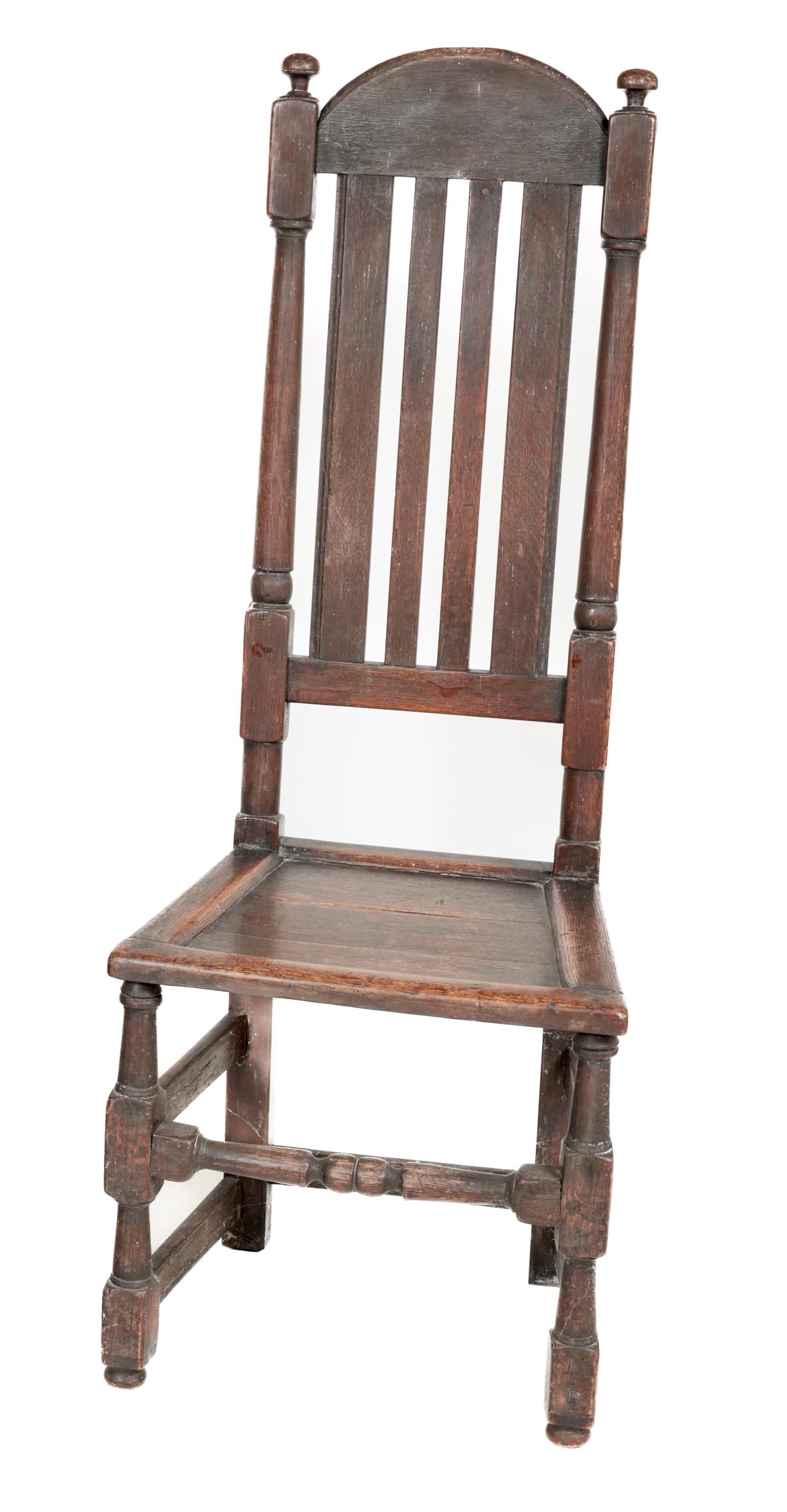 An 18th Century oak high back Side Chair, the latted back with dome top and finial mounts, above a